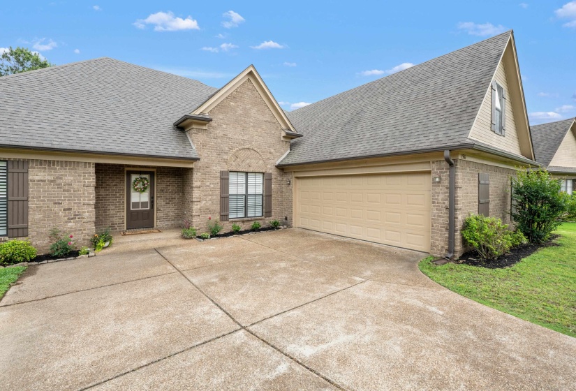 Brick exterior with gabled roof lines and a two-car garage