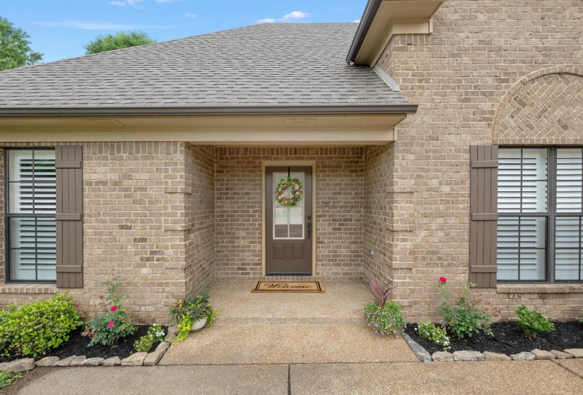 Brick exterior featuring a covered entry