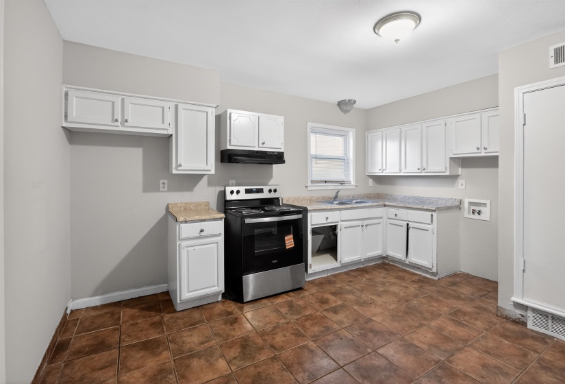 Kitchen featuring white cabinetry, stone-finish countertops, and a full-size range