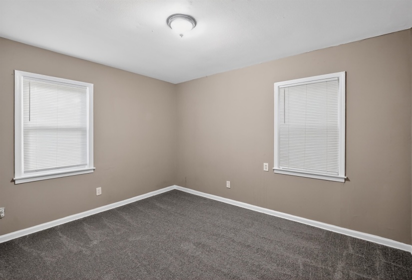 Neutral-toned walls complement the gray carpeting
