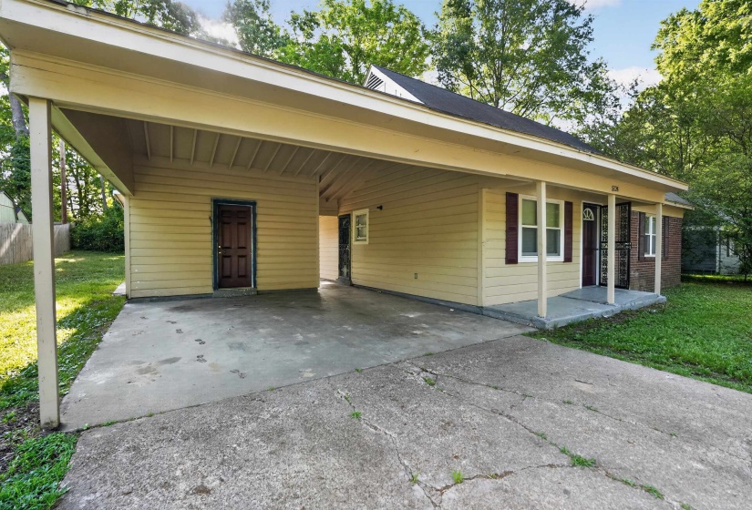 Exterior featuring a covered carport, concrete driveway, and a front porch