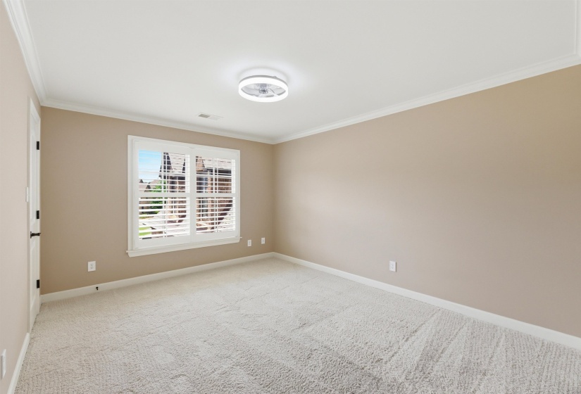 Spacious room featuring plush carpeting and neutral tone walls