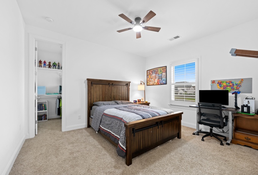 Bright room featuring neutral carpeting and white walls