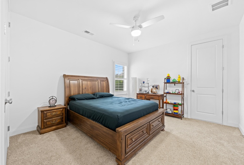 Spacious room featuring carpeting, a ceiling fan with integrated lighting, and white interior doors