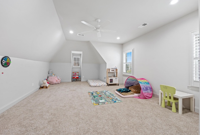 Spacious bonus room featuring neutral carpeting and white wall paint