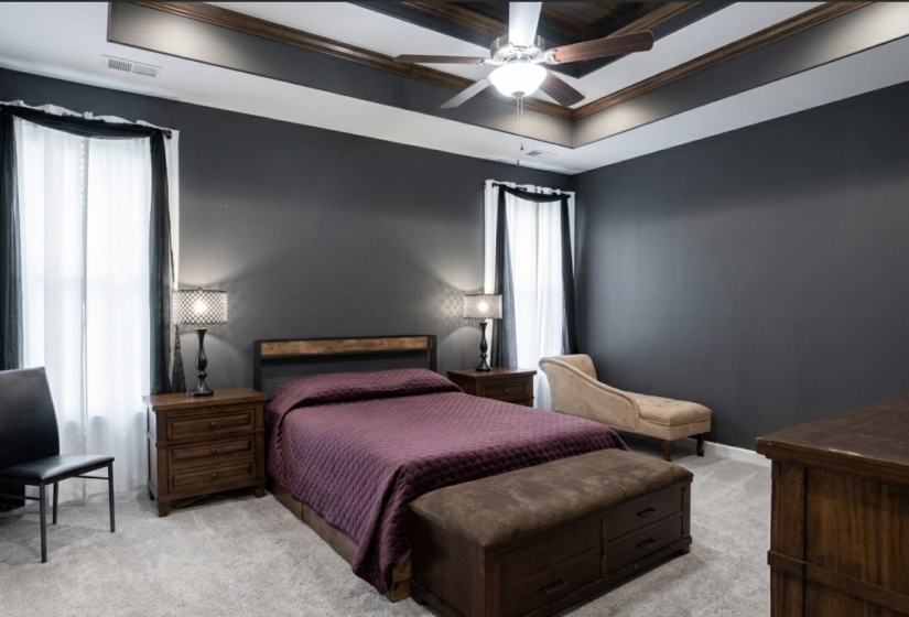Tray ceiling with wood-finish trim and ceiling fan