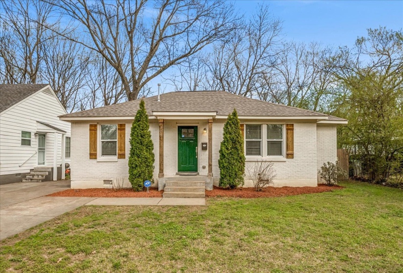 View of front of house with entry steps, brick siding, a front yard, and roof with shingles
