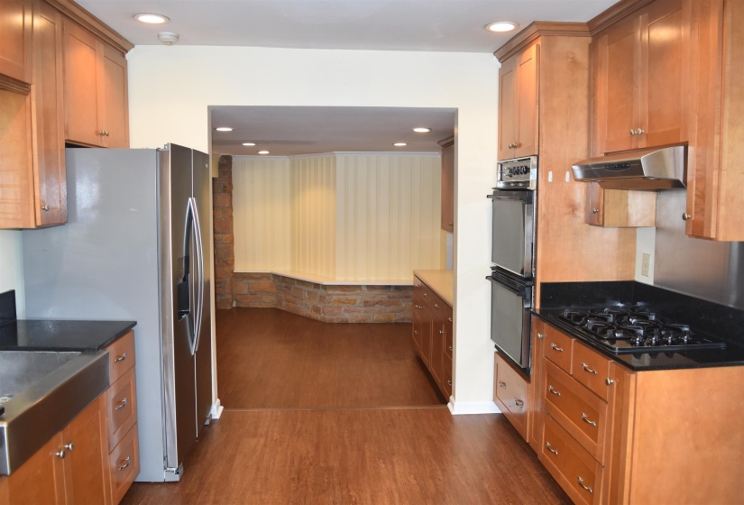 Kitchen featuring wood-finish flooring, recessed lighting, and light wood cabinetry with brushed nickel hardware