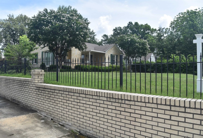 Cream brick exterior featuring dark shutters