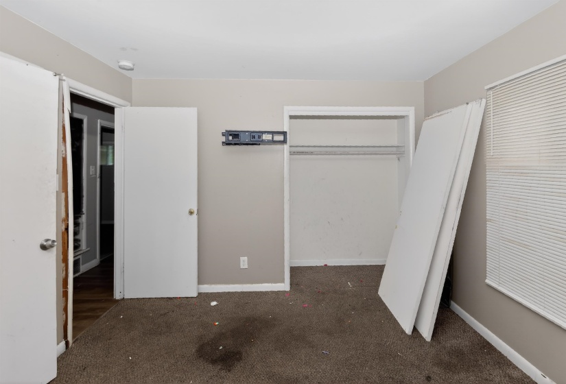 Carpeted interior space with neutral wall paint and white trim