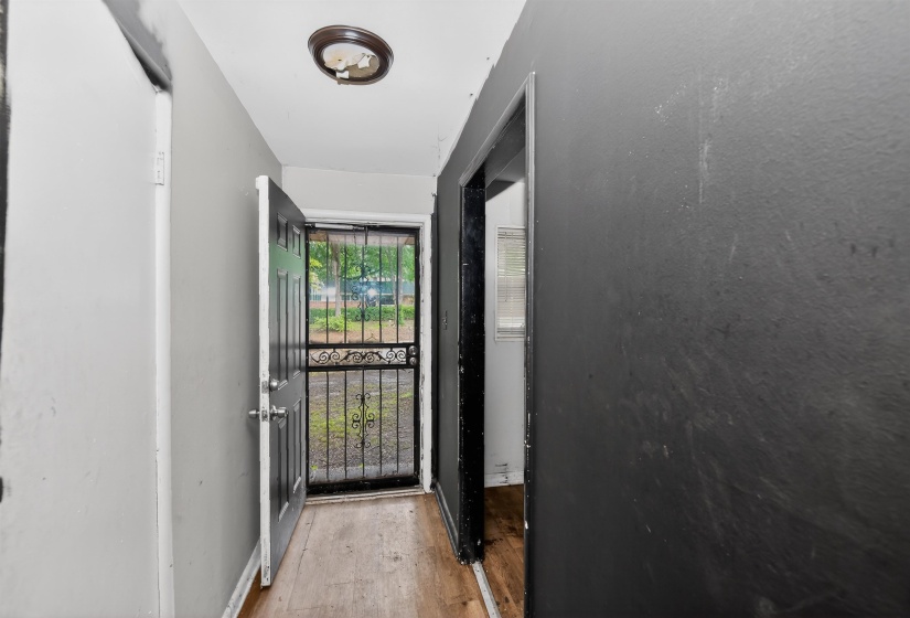 Entryway featuring a wood-finish floor and a security screen door