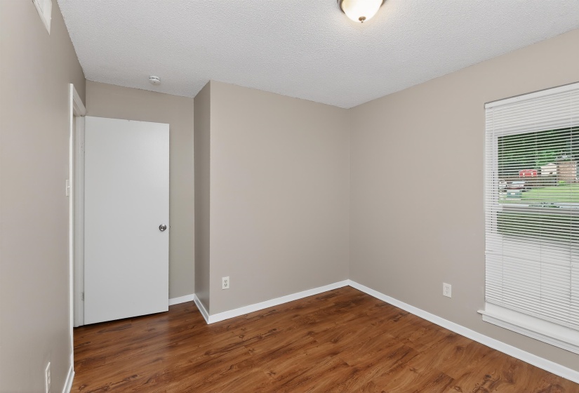 Neutral-toned walls with white trim and wood-finish flooring