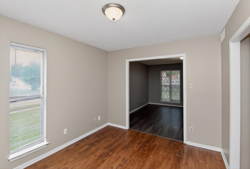 Interior room featuring wood-finish flooring, neutral wall paint, and a semi-flush ceiling light fixture