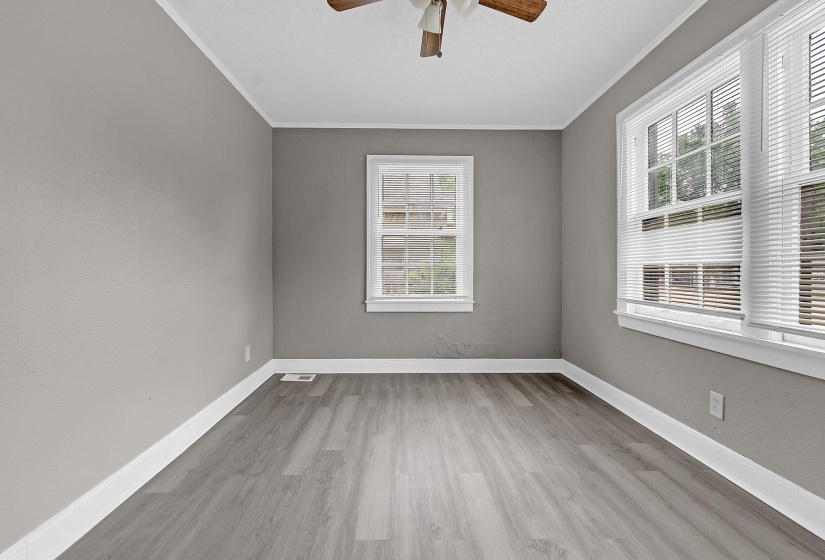 Interior room featuring light gray wall paint and wood-finish flooring