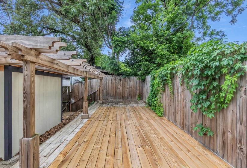 Expansive wood deck with a pergola structure