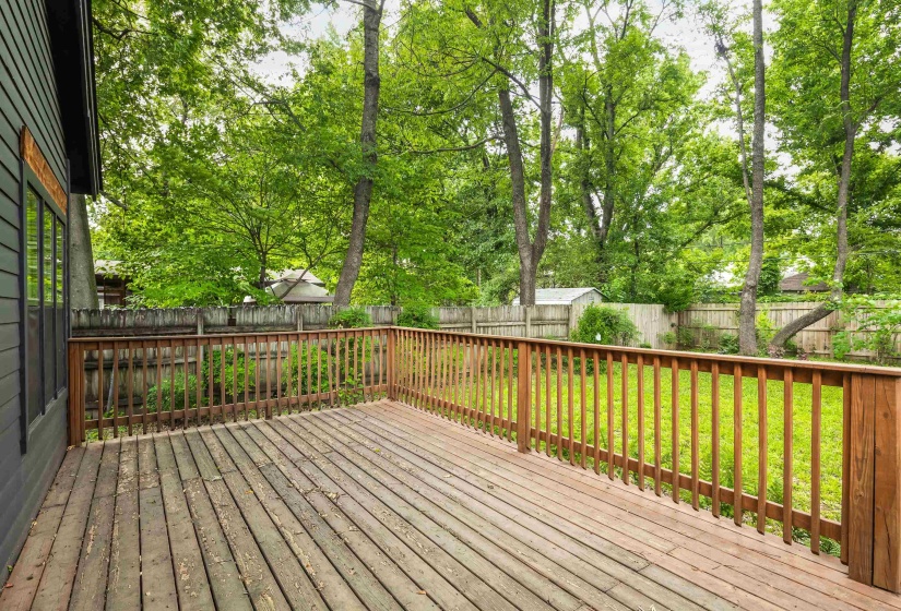 Wood-finish deck with a natural wood railing, featuring a spacious outdoor area