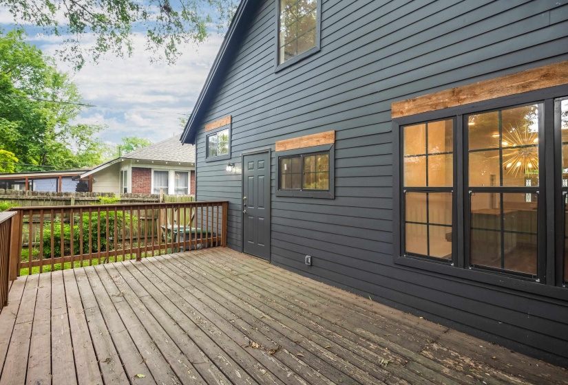 Spacious outdoor wood deck with natural wood railing