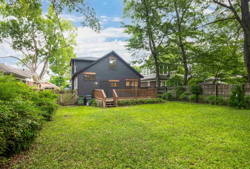Expansive green yard with mature perimeter trees