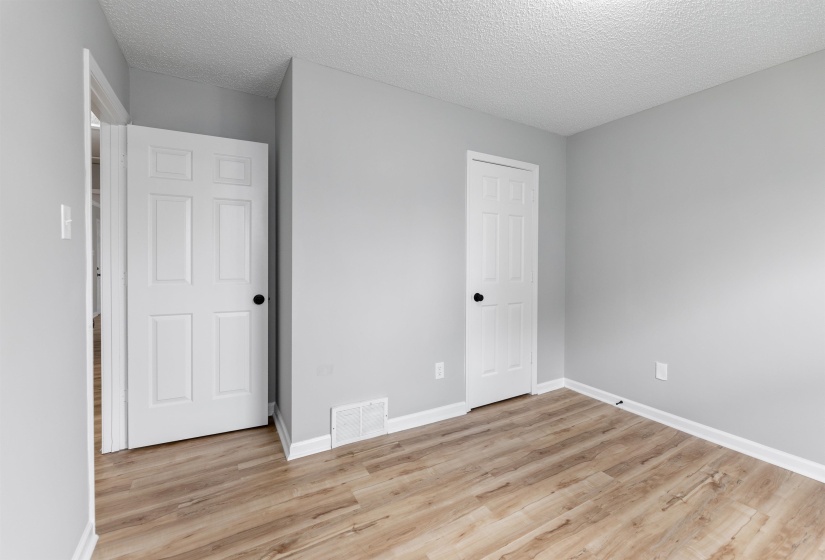 Room featuring light wood-finish flooring, light gray walls, and white baseboards