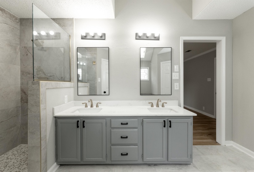 Dual vanity with white countertops, grey cabinetry, and brushed nickel hardware