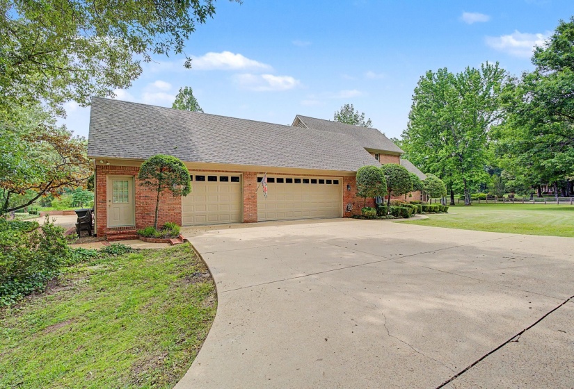 Brick exterior with 3-car Garage. *Door to left of garage goes into a separate workshop with permanent stairs to unfinished Bonus Room