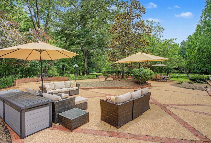 Expansive outdoor patio featuring a patterned brick and aggregate surface