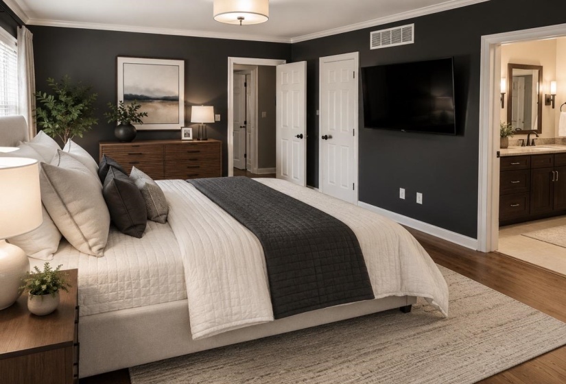 Bedroom featuring dark accent walls, white trim, and wood-finish flooring