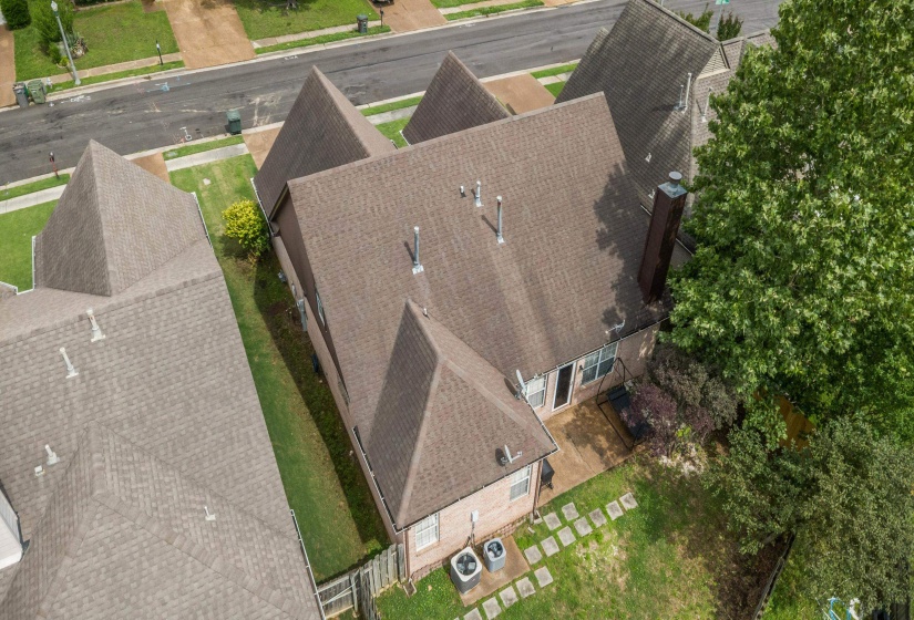 Aerial perspective showcasing a residential property with a multi-gabled roofline