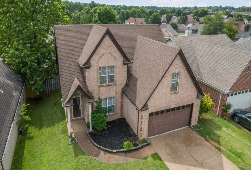 Brick exterior with a gabled roofline, an arched entry, and a covered porch