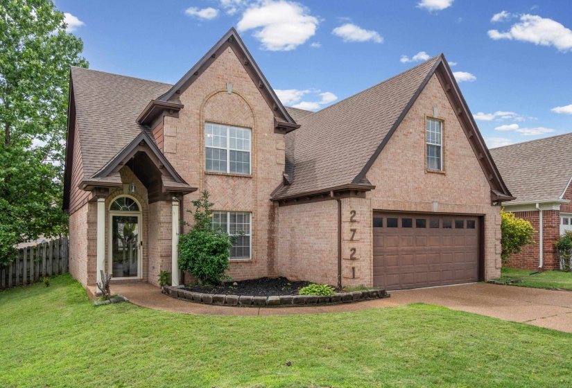 Brick exterior with an arched entryway and covered porch