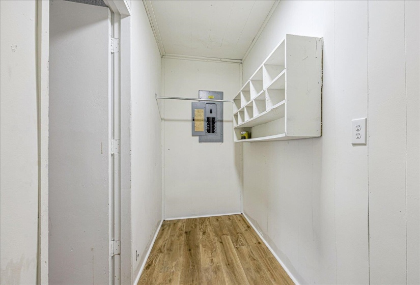 Hallway with light wood-style flooring and electric panel