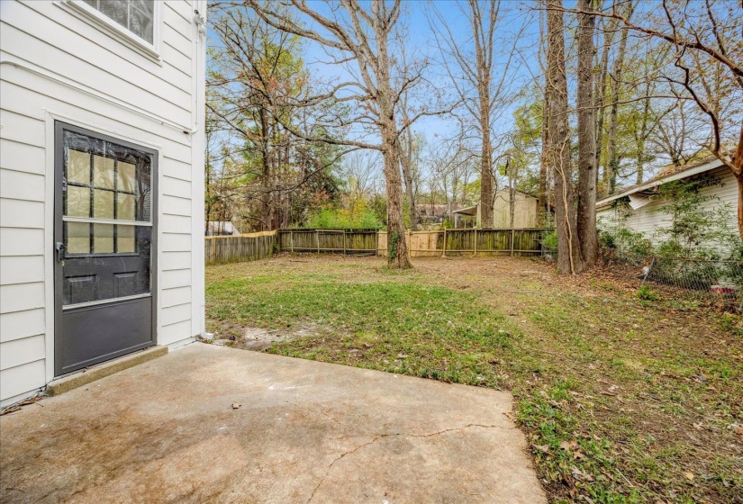 Fenced backyard with a patio