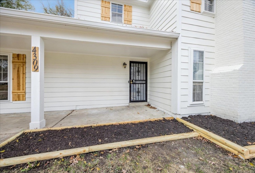 View of exterior entry featuring covered porch
