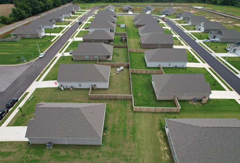 Residential neighborhood featuring multiple single-story homes with shingle roofs and light-colored siding