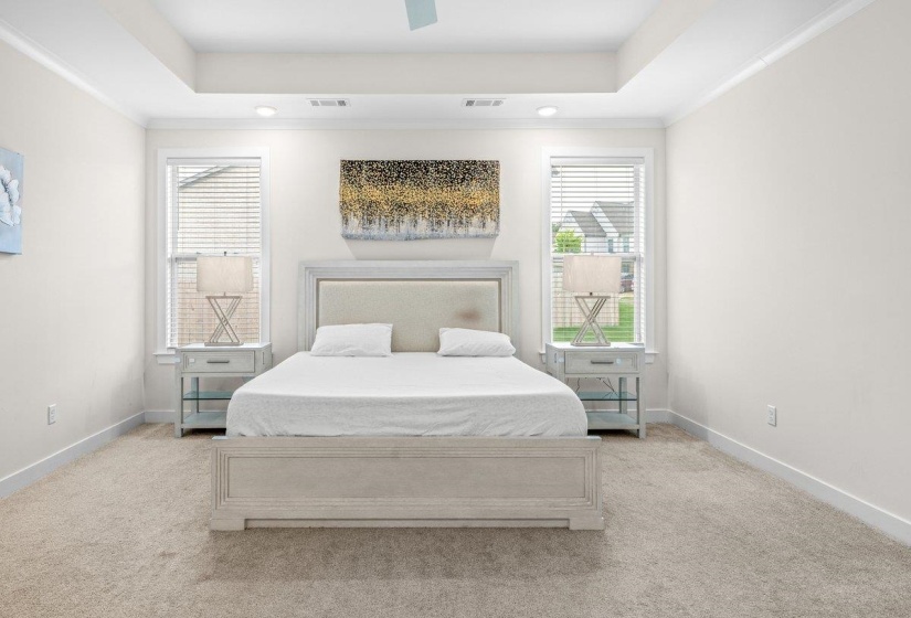 Bedroom featuring a tray ceiling, recessed lighting, and carpet flooring