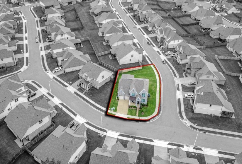 Corner lot property featuring a light blue siding exterior and an attached two-car garage