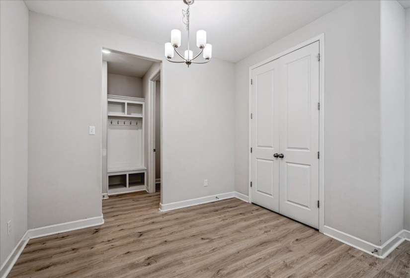 Wood-finish flooring throughout, complemented by a built-in hall tree with shelving and coat hooks