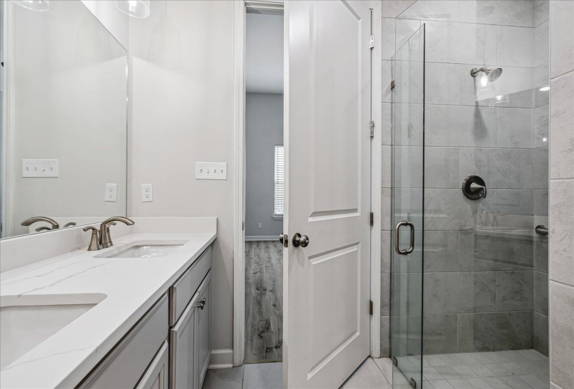 Bathroom featuring a dual vanity with undermount sinks, white countertops, and brushed nickel faucets
