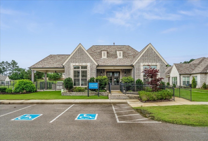Stone and brick exterior featuring multiple gables and dormer windows, a covered entryway with a ramp, and a covered side patio
