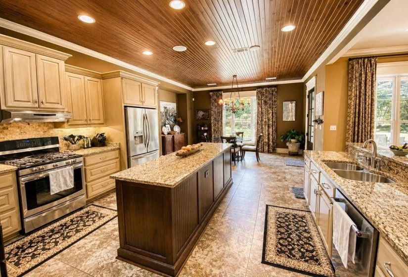 Kitchen featuring a wood-panel ceiling with recessed lighting, granite countertops, and stainless steel appliances