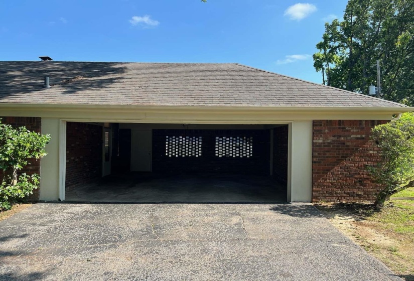 Two-car carport with a paved asphalt driveway