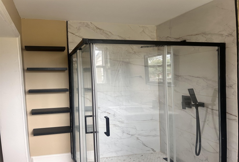 Full bathroom with a marble finish shower