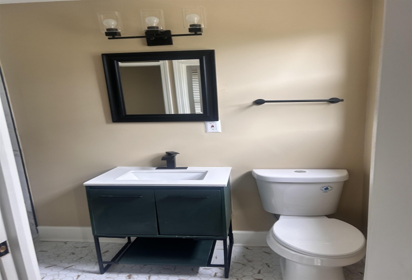 Bathroom with vanity and baseboards