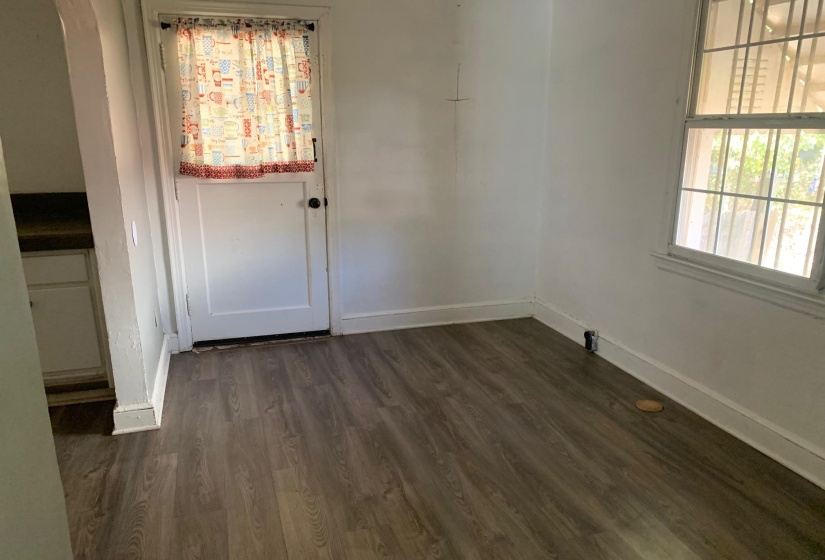 Empty room with dark hardwood / wood-style floors