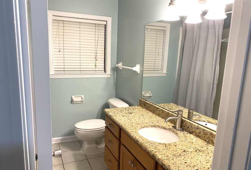 Bathroom with tile patterned flooring, vanity, and toilet