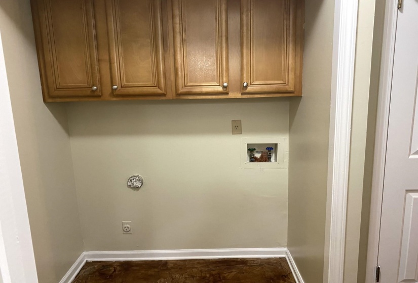 Washroom with washer hookup, cabinets, and hookup for an electric dryer