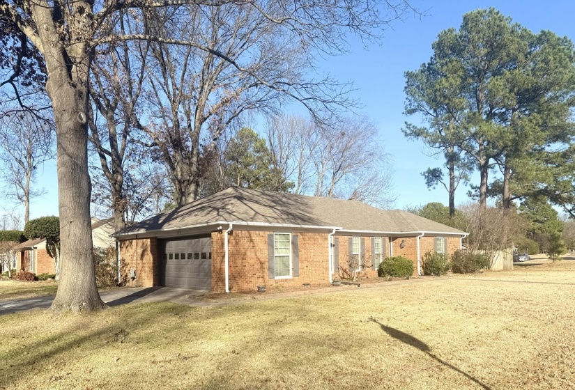 View of front of house with a garage and a front lawn