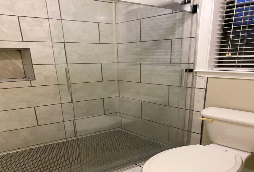 Bathroom featuring toilet and walk in shower