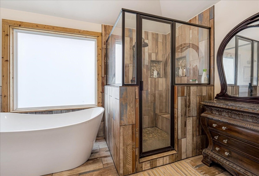 Full bath with a shower stall and a soaking tub