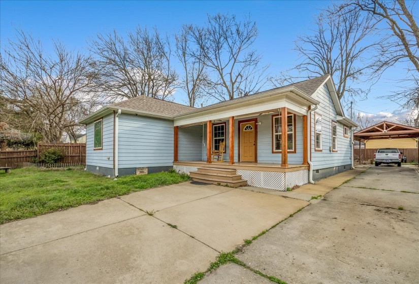 View of front of house featuring crawl space, a porch, roof with shingles, and driveway